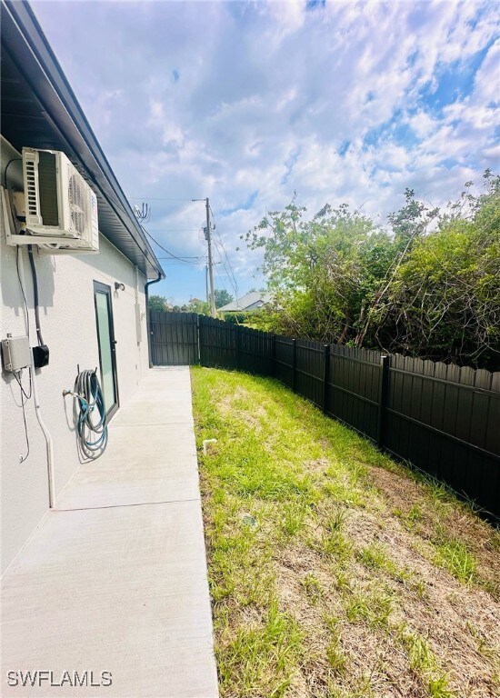 3016 6th St W, Lehigh Acres, FL 33971 - view of yard with ac unit