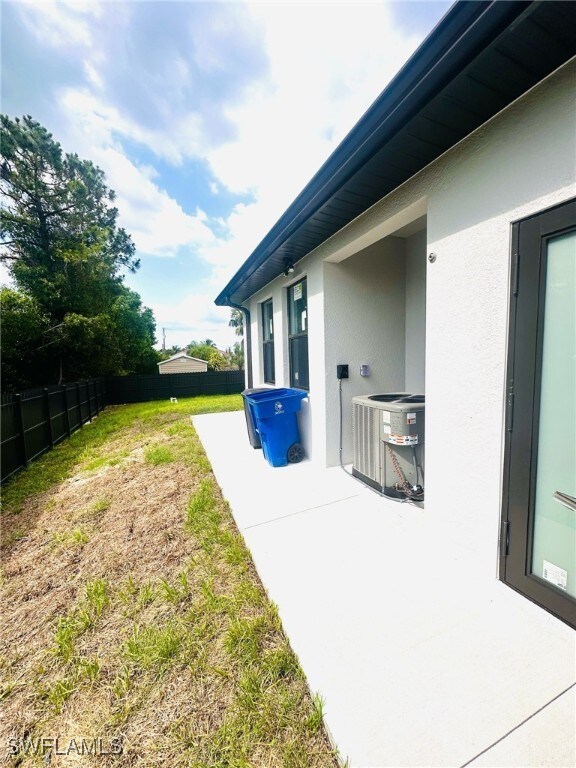 3016 6th St W, Lehigh Acres, FL 33971 - view of yard featuring central AC and a patio area