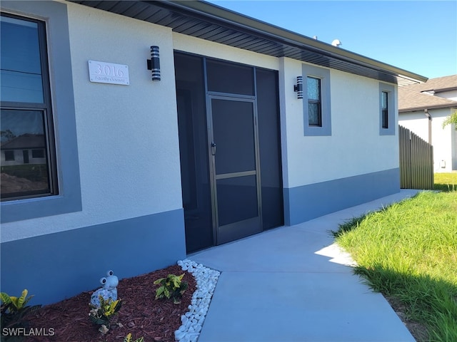 3016 6th St W, Lehigh Acres, FL 33971 - doorway to property with stucco siding
