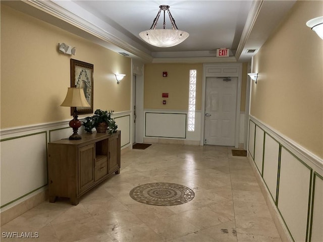 1516 SW 50th St Unit 104, Cape Coral, FL 33914 - entryway featuring a decorative wall, a wainscoted wall, and a raised ceiling