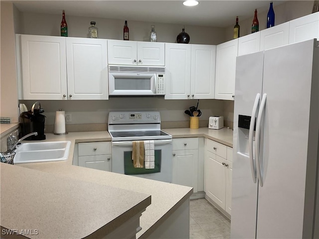 1516 SW 50th St Unit 104, Cape Coral, FL 33914 - kitchen with white appliances, a sink, white cabinetry, light countertops, and recessed lighting