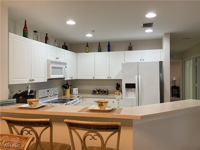 1516 SW 50th St Unit 104, Cape Coral, FL 33914 - kitchen with white appliances, light countertops, white cabinets, and recessed lighting