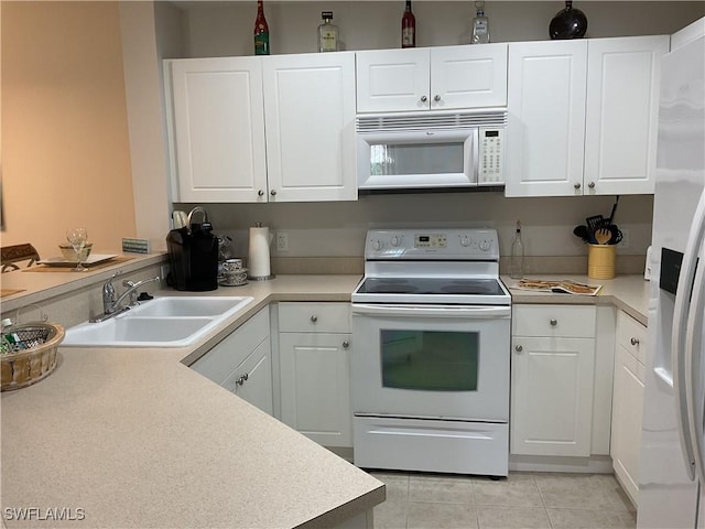 1516 SW 50th St Unit 104, Cape Coral, FL 33914 - kitchen with white appliances, a sink, light tile patterned floors, and white cabinetry