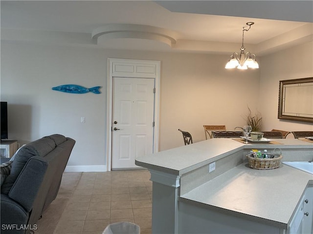 1516 SW 50th St Unit 104, Cape Coral, FL 33914 - kitchen featuring light tile patterned flooring, a chandelier, hanging light fixtures, light countertops, and baseboards