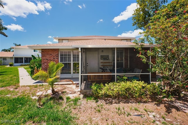 3350 Alouette Cir Unit 1, Fort Myers, FL 33907 - rear view of property with brick siding, a sunroom, and a shingled roof