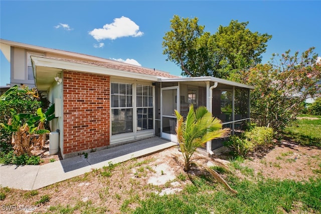 3350 Alouette Cir Unit 1, Fort Myers, FL 33907 - back of house with a sunroom and brick siding