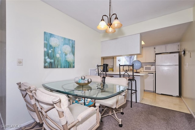 3350 Alouette Cir Unit 1, Fort Myers, FL 33907 - dining room featuring a chandelier and light colored carpet