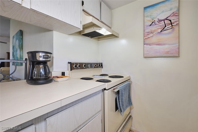 3350 Alouette Cir Unit 1, Fort Myers, FL 33907 - kitchen with white range with electric stovetop, under cabinet range hood, and light countertops