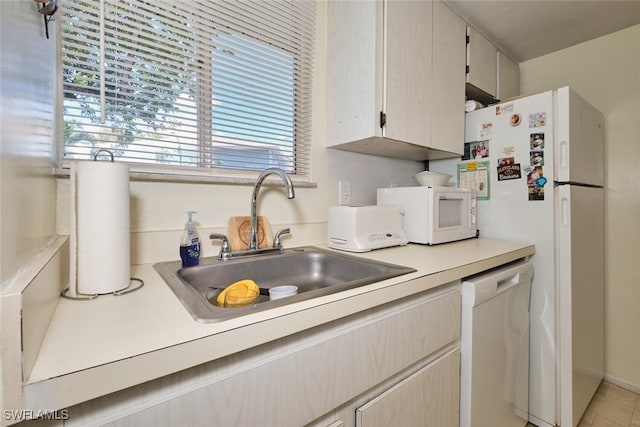 3350 Alouette Cir Unit 1, Fort Myers, FL 33907 - kitchen with white appliances, a sink, healthy amount of natural light, and light countertops