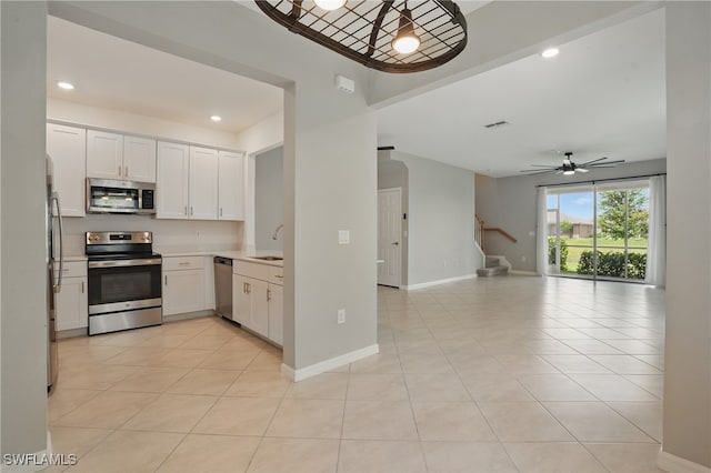 2810 Blossom Way, Naples, FL 34120 - kitchen featuring stainless steel appliances, a sink, white cabinetry, light countertops, and light tile patterned floors
