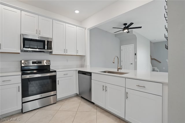 2810 Blossom Way, Naples, FL 34120 - kitchen featuring stainless steel appliances, a sink, light countertops, ceiling fan, and light tile patterned floors