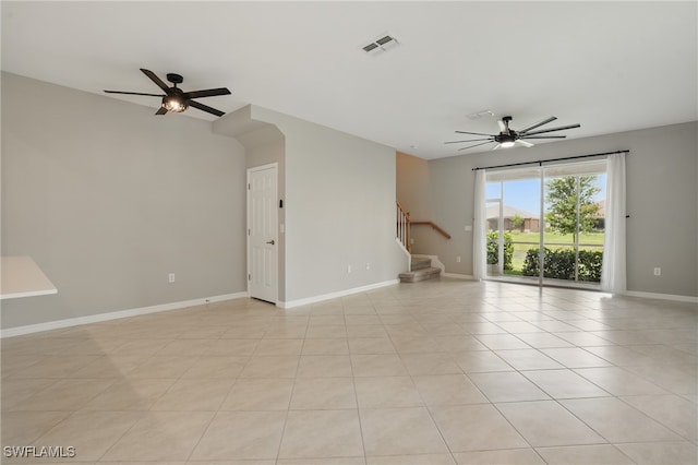 2810 Blossom Way, Naples, FL 34120 - empty room featuring a ceiling fan, stairway, baseboards, and light tile patterned flooring