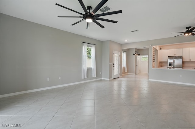 2810 Blossom Way, Naples, FL 34120 - unfurnished living room with a ceiling fan, light tile patterned floors, and baseboards