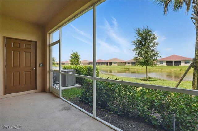 2810 Blossom Way, Naples, FL 34120 - unfurnished sunroom with a water view
