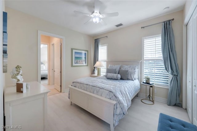 6419 Vivaldi Ct, Naples, FL 34113 - bedroom with baseboards, light wood-style floors, and a ceiling fan