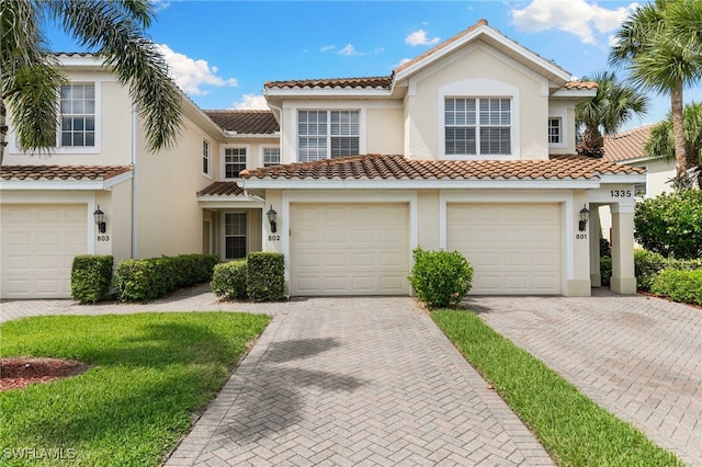 1335 Henley St Unit 802, Naples, FL 34105 - view of front of house with driveway, a tile roof, stucco siding, and a garage
