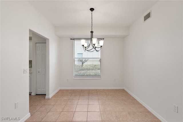 1335 Henley St Unit 802, Naples, FL 34105 - spare room featuring a chandelier, baseboards, and light tile patterned floors