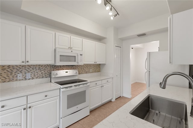 1335 Henley St Unit 802, Naples, FL 34105 - kitchen featuring white appliances, a sink, white cabinetry, and backsplash