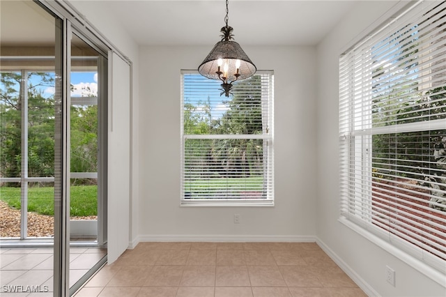 1335 Henley St Unit 802, Naples, FL 34105 - unfurnished dining area with light tile patterned floors, a chandelier, and baseboards