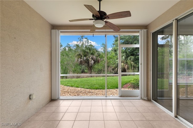 1335 Henley St Unit 802, Naples, FL 34105 - unfurnished sunroom featuring a textured wall, plenty of natural light, and tile patterned flooring
