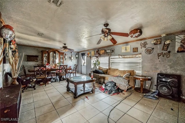 living room with a ceiling fan and light tile patterned flooring