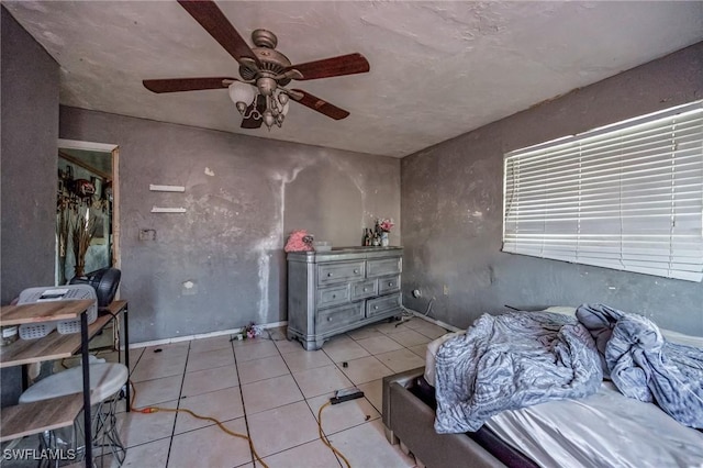 bedroom featuring light tile patterned flooring and a ceiling fan