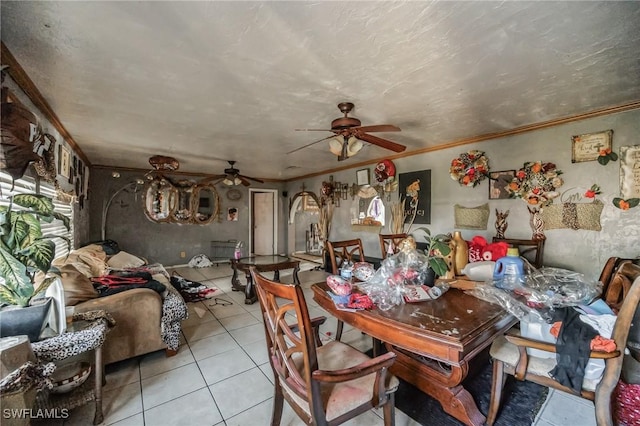 dining room featuring tile patterned floors, a ceiling fan, and crown molding
