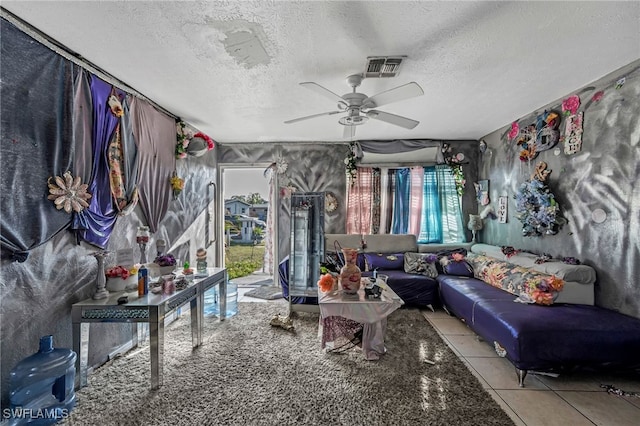 living area with a textured ceiling and a ceiling fan