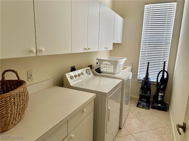 28171 L Burton Fletcher Ct, Bonita Springs, FL 34135 - laundry area with cabinet space, washer and dryer, baseboards, and light tile patterned floors