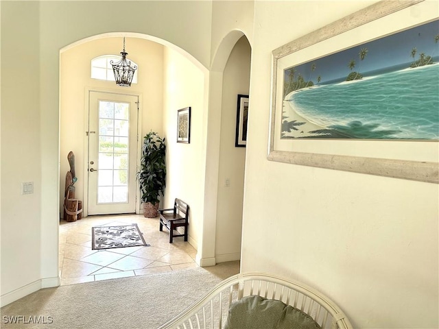 28171 L Burton Fletcher Ct, Bonita Springs, FL 34135 - tiled foyer with carpet flooring, baseboards, and arched walkways