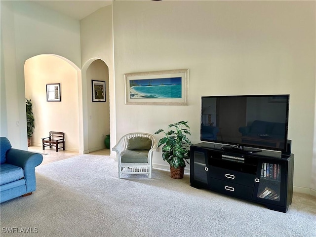 28171 L Burton Fletcher Ct, Bonita Springs, FL 34135 - carpeted living room featuring arched walkways and baseboards