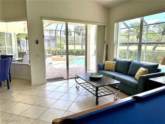 28171 L Burton Fletcher Ct, Bonita Springs, FL 34135 - living room with light tile patterned floors, baseboards, and a sunroom