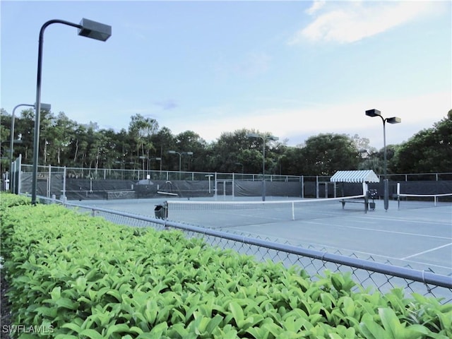 28171 L Burton Fletcher Ct, Bonita Springs, FL 34135 - view of tennis court featuring view of scattered trees