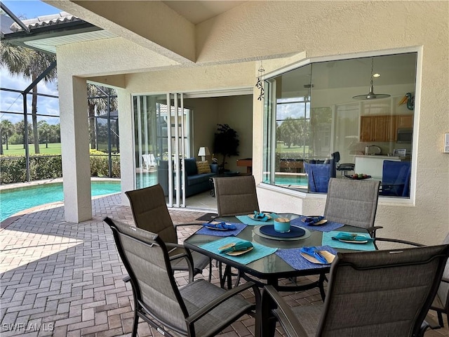 28171 L Burton Fletcher Ct, Bonita Springs, FL 34135 - view of patio / terrace with an outdoor pool, glass enclosure, and outdoor dining space