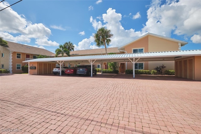1124 SW 48th Ter Unit 208, Cape Coral, FL 33914 - view of front of property featuring covered parking and stucco siding