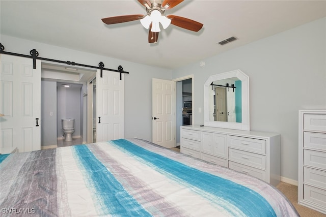 1124 SW 48th Ter Unit 208, Cape Coral, FL 33914 - bedroom with a barn door, baseboards, ensuite bathroom, and ceiling fan