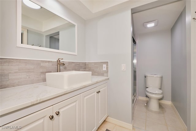 1124 SW 48th Ter Unit 208, Cape Coral, FL 33914 - full bathroom with toilet, backsplash, vanity, tile patterned flooring, and a shower stall