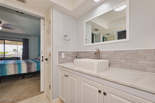 1124 SW 48th Ter Unit 208, Cape Coral, FL 33914 - bathroom featuring ensuite bath, vanity, ceiling fan, tile patterned floors, and tasteful backsplash