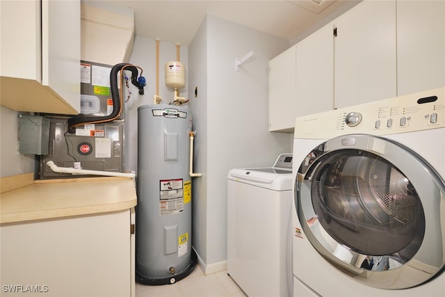 1124 SW 48th Ter Unit 208, Cape Coral, FL 33914 - laundry room with water heater, washing machine and clothes dryer, cabinet space, and light tile patterned floors