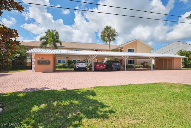 1124 SW 48th Ter Unit 208, Cape Coral, FL 33914 - view of front of property featuring metal roof, a front lawn, and stucco siding
