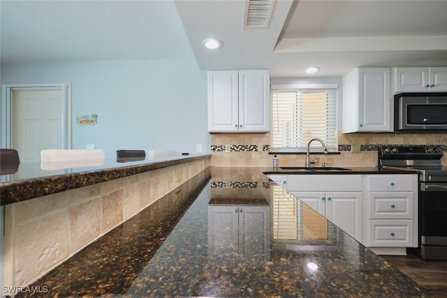1124 SW 48th Ter Unit 208, Cape Coral, FL 33914 - kitchen with appliances with stainless steel finishes, a sink, white cabinets, tasteful backsplash, and recessed lighting