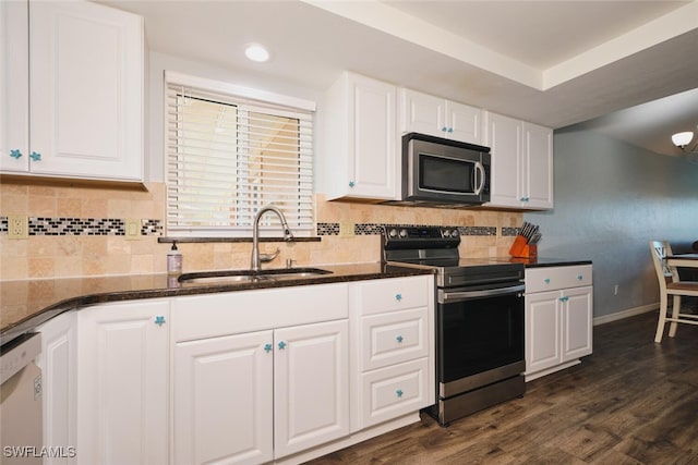 1124 SW 48th Ter Unit 208, Cape Coral, FL 33914 - kitchen featuring stainless steel appliances, a sink, white cabinets, dark stone counters, and dark wood-style flooring