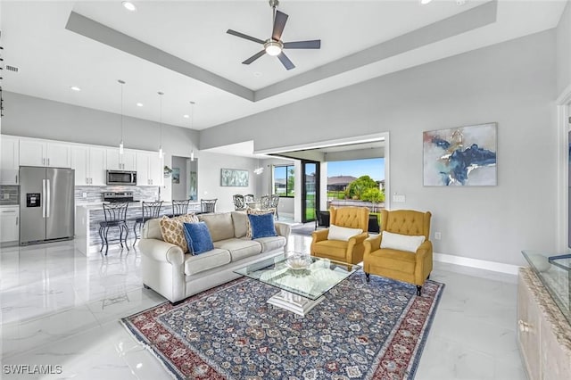 1409 SW 24th St, Cape Coral, FL 33991 - living room featuring light marble finish floors, recessed lighting, a raised ceiling, ceiling fan, and baseboards