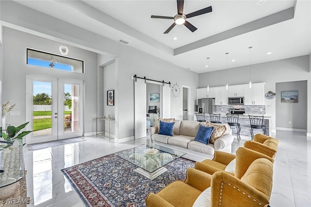 1409 SW 24th St, Cape Coral, FL 33991 - living area with light marble finish flooring, a barn door, ceiling fan, recessed lighting, and baseboards