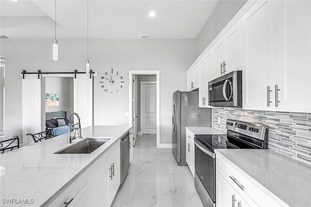 1409 SW 24th St, Cape Coral, FL 33991 - kitchen featuring appliances with stainless steel finishes, a sink, light marble finish floors, backsplash, and light stone counters