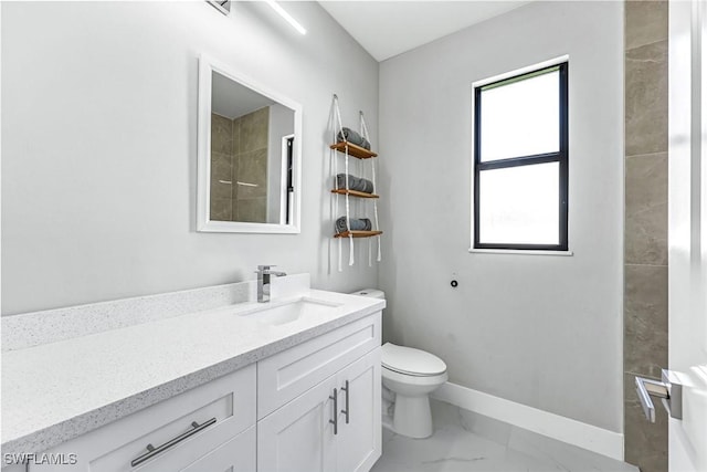 1409 SW 24th St, Cape Coral, FL 33991 - bathroom featuring marble look tiles, vanity, baseboards, and toilet