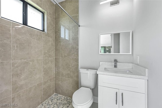 1409 SW 24th St, Cape Coral, FL 33991 - full bathroom featuring a tile shower, toilet, and vanity