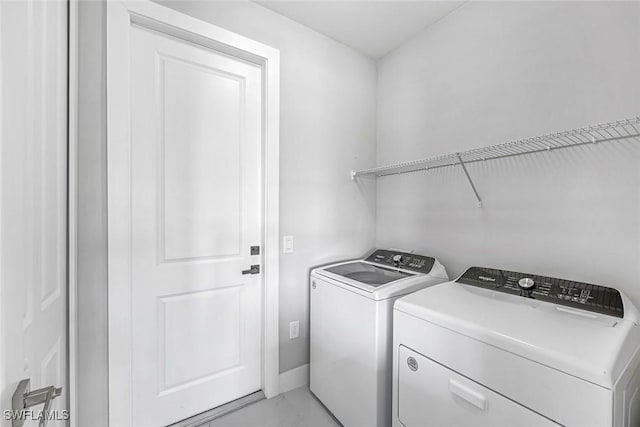 1409 SW 24th St, Cape Coral, FL 33991 - laundry room featuring washer and clothes dryer and light marble finish floors
