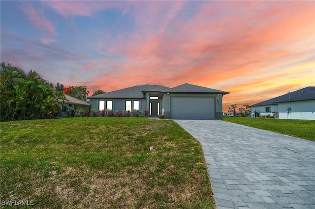 3410 NW 17th Ln, Cape Coral, FL 33993 - view of front of property with an attached garage, a lawn, and decorative driveway
