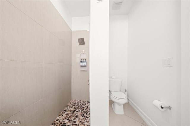 3410 NW 17th Ln, Cape Coral, FL 33993 - bathroom with toilet, a tile shower, tile patterned flooring, and baseboards
